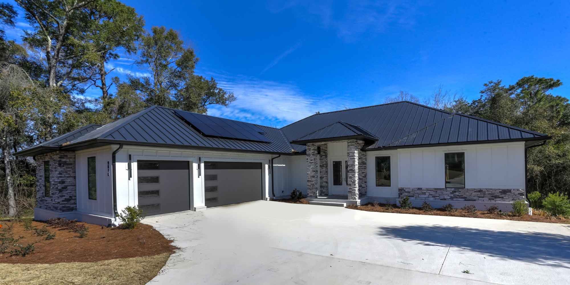 A custom home with a connected garage built on a slab foundation in Pensacola by Urban Infill.