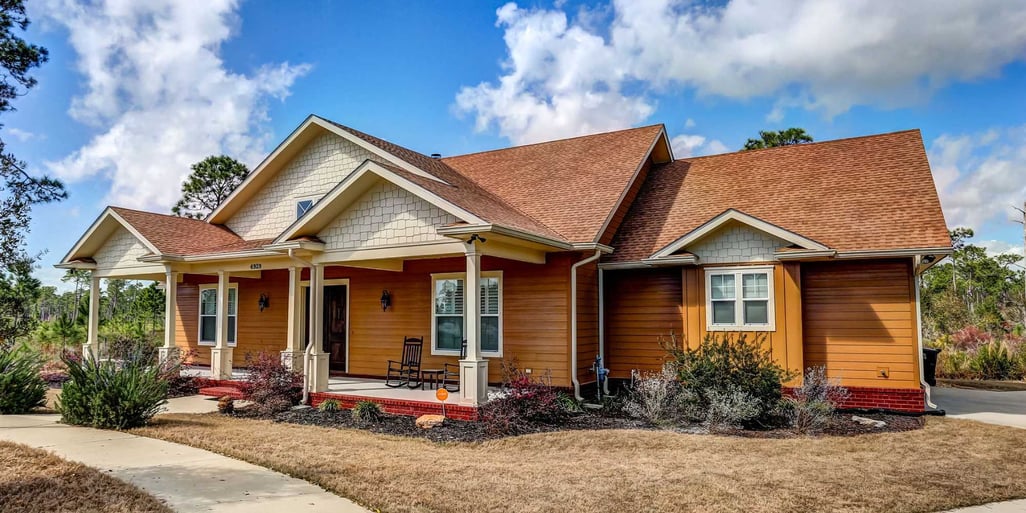 A custom home in Pensacola with a covered front porch by Urban Infill