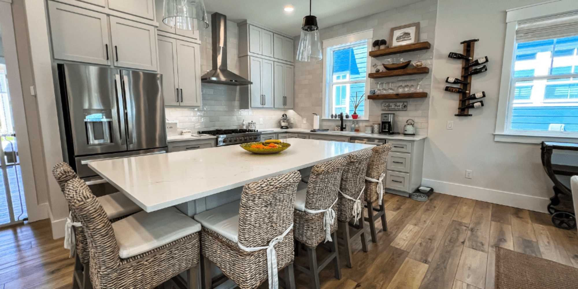 Contemporary open kitchen remodel featuring a large island with seating in Pensacola by Urban Infill
