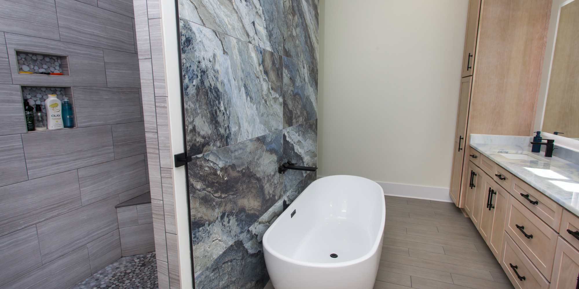 Walk-in shower, soaking tub, and a dual vanity in a custom home by Urban Infill in Pensacola, FL