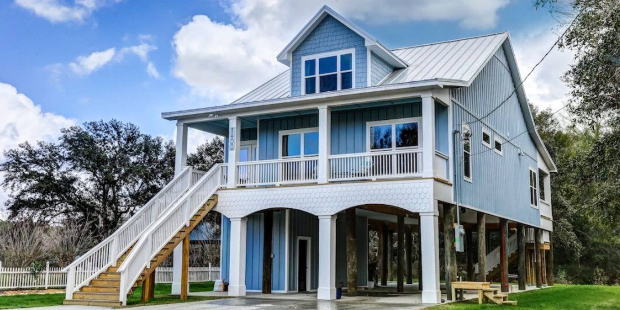 Elevated blue siding custom home by Urban Infill in East Pensacola Heights