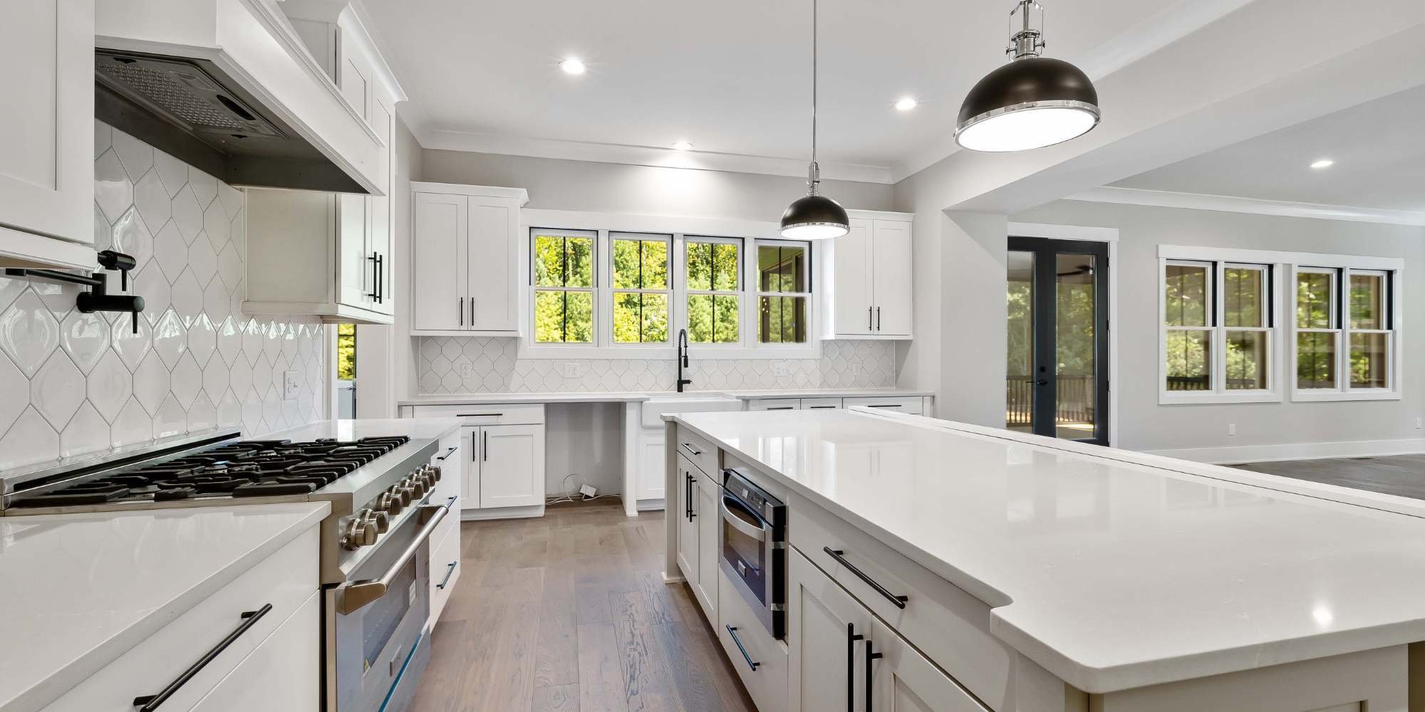 Luxury Pensacola kitchen renovation with farmhouse sink, gas range, and oversized island for entertaining
