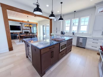 Image of kitchen remodel with large island, wood accents, and open concept layout in Pensacola, FL by Urban Infill