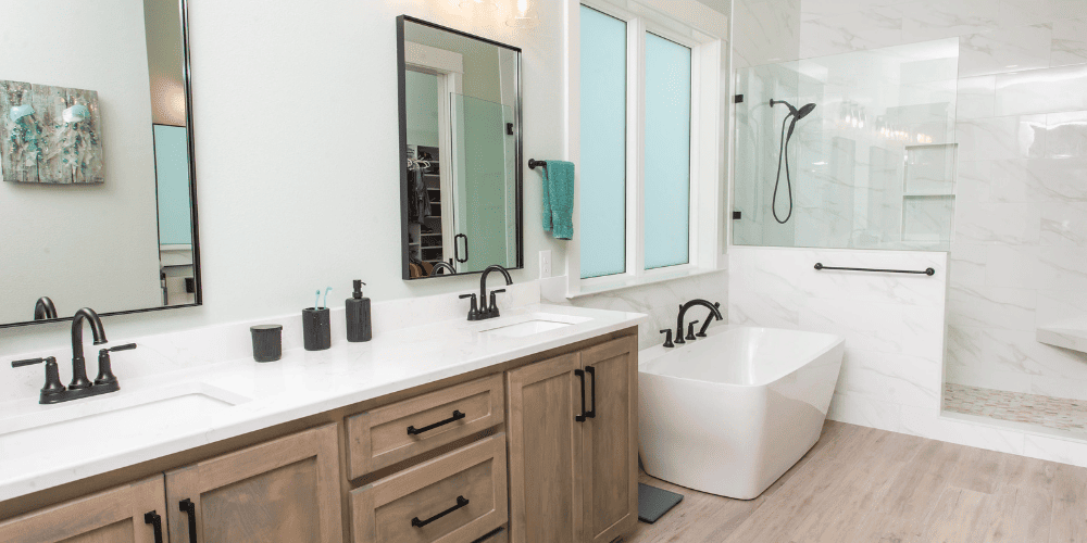 Remodeled bathroom with two sinks a bathtub and a shower in Pensacola by Urban Infill
